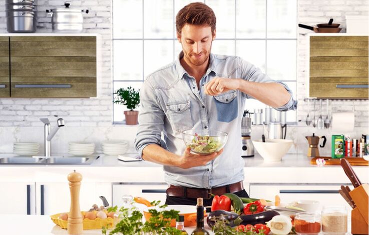 a man prepares a vegetable salad to increase potency